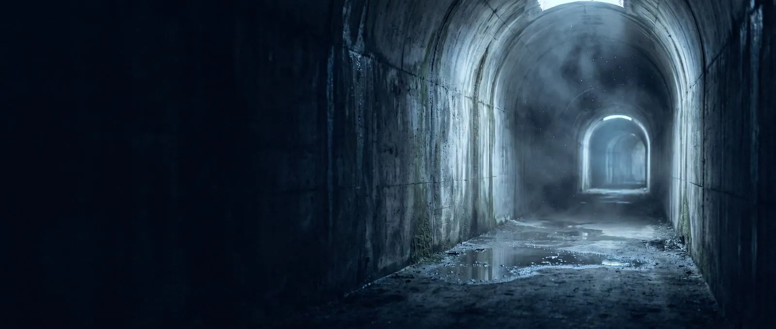 An empty concrete tunnel receding into cold light (AI-generated atmosphere)