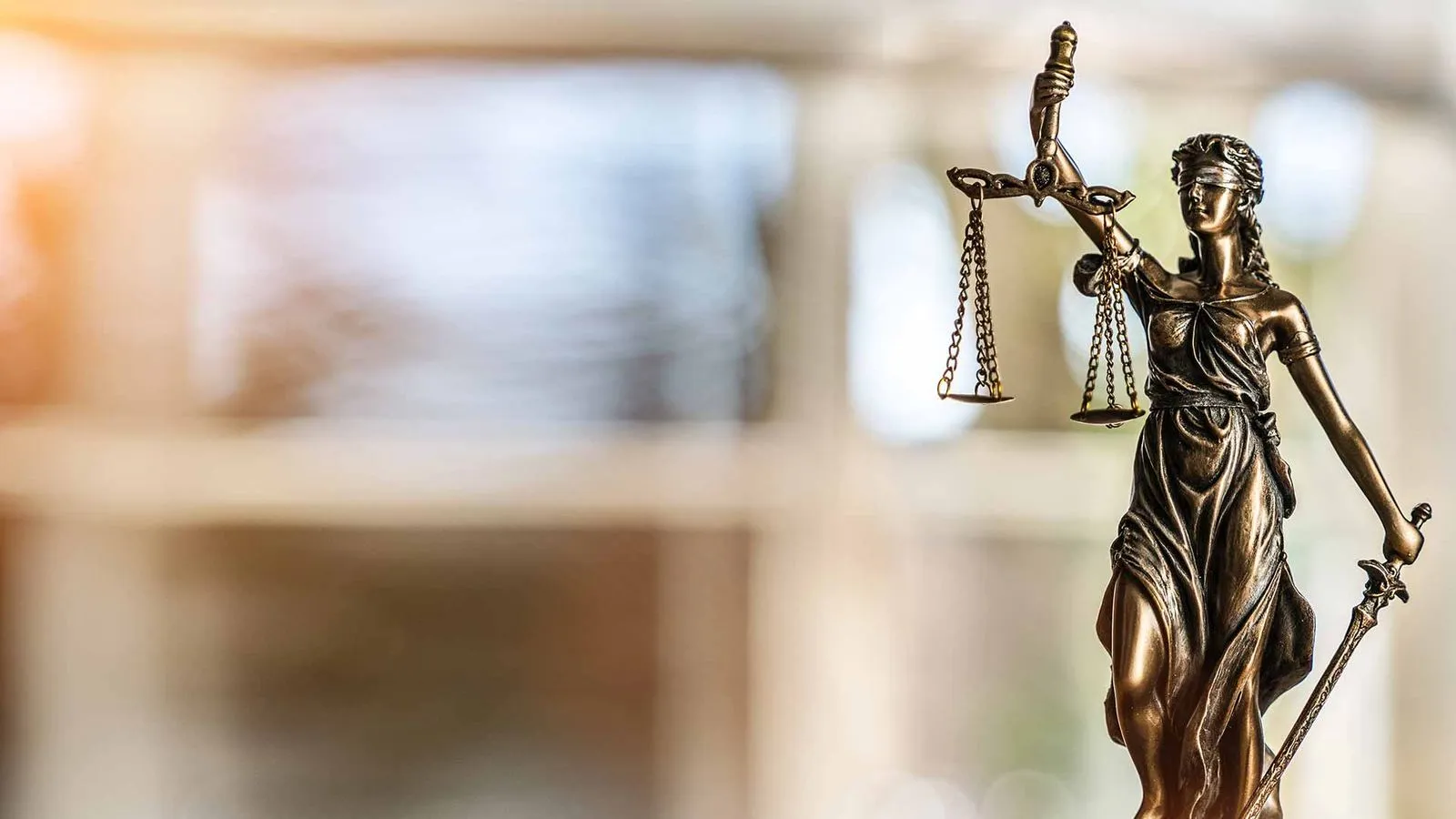 Bronze statue of Lady Justice holding the scales