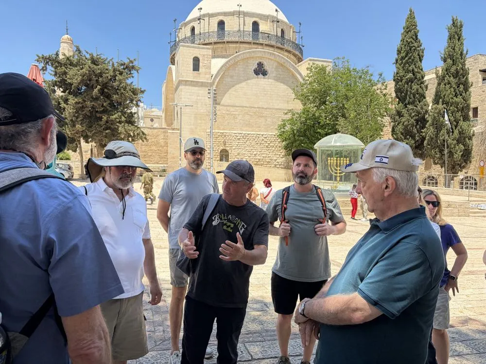 Participants gathered in a stone plaza in Jerusalem’s Old City