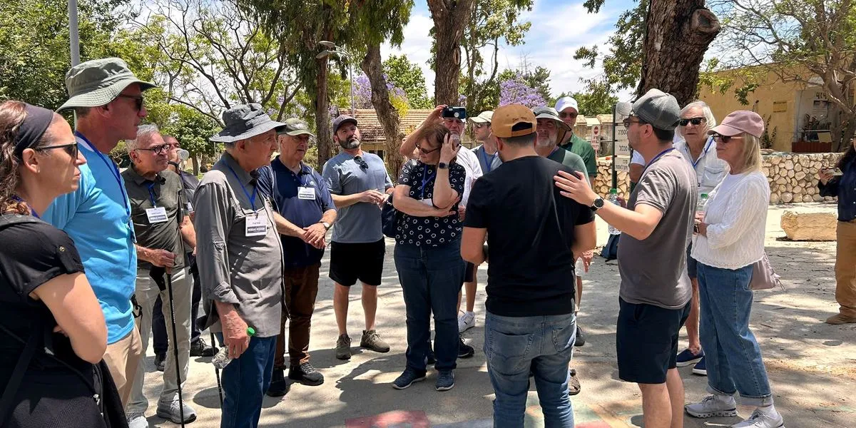 Mission participants gather around a guide outdoors
