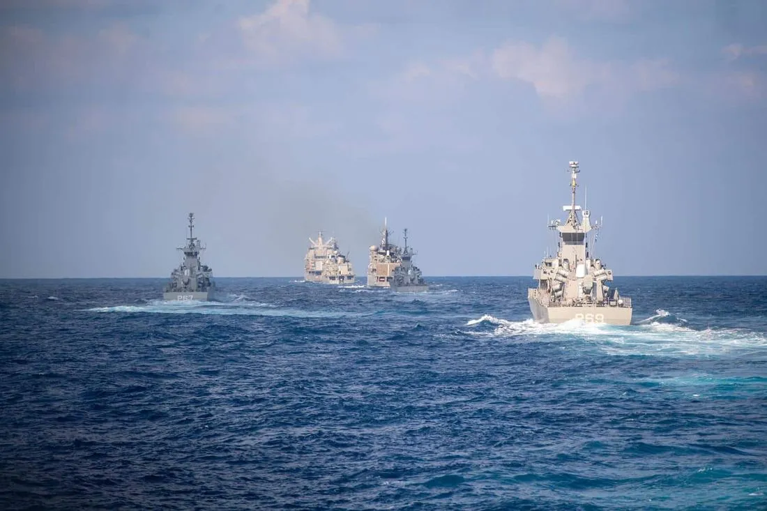 Naval vessels sailing in formation at sea